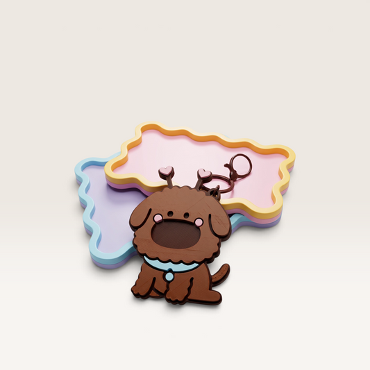 iTsChoCoBu brown puppy keychain mirror with heart-tipped antennae and blue collar on pastel bone-shaped backgrounds