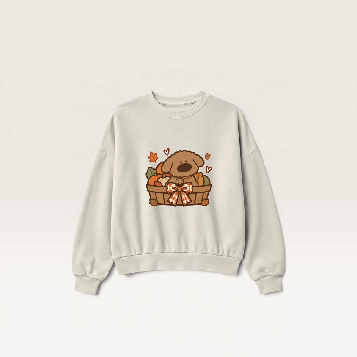 iTsChoCoBu Autumn Basket beige sweatshirt featuring a cute puppy in a pumpkin-filled basket graphic