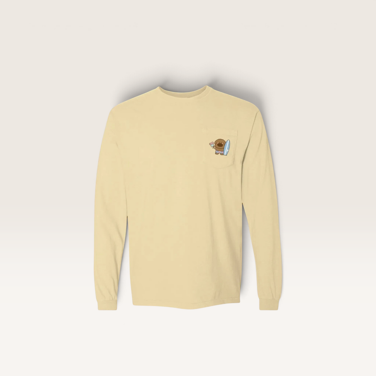 iTsChoCoBu cream long sleeve pocket t-shirt with a small cute cartoon character graphic on the chest pocket
