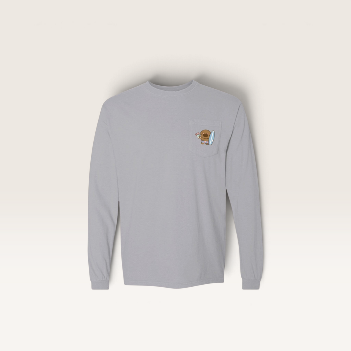 iTsChoCoBu grey long sleeve pocket t-shirt with a small graphic of a cartoon bear holding a surfboard on the pocket.