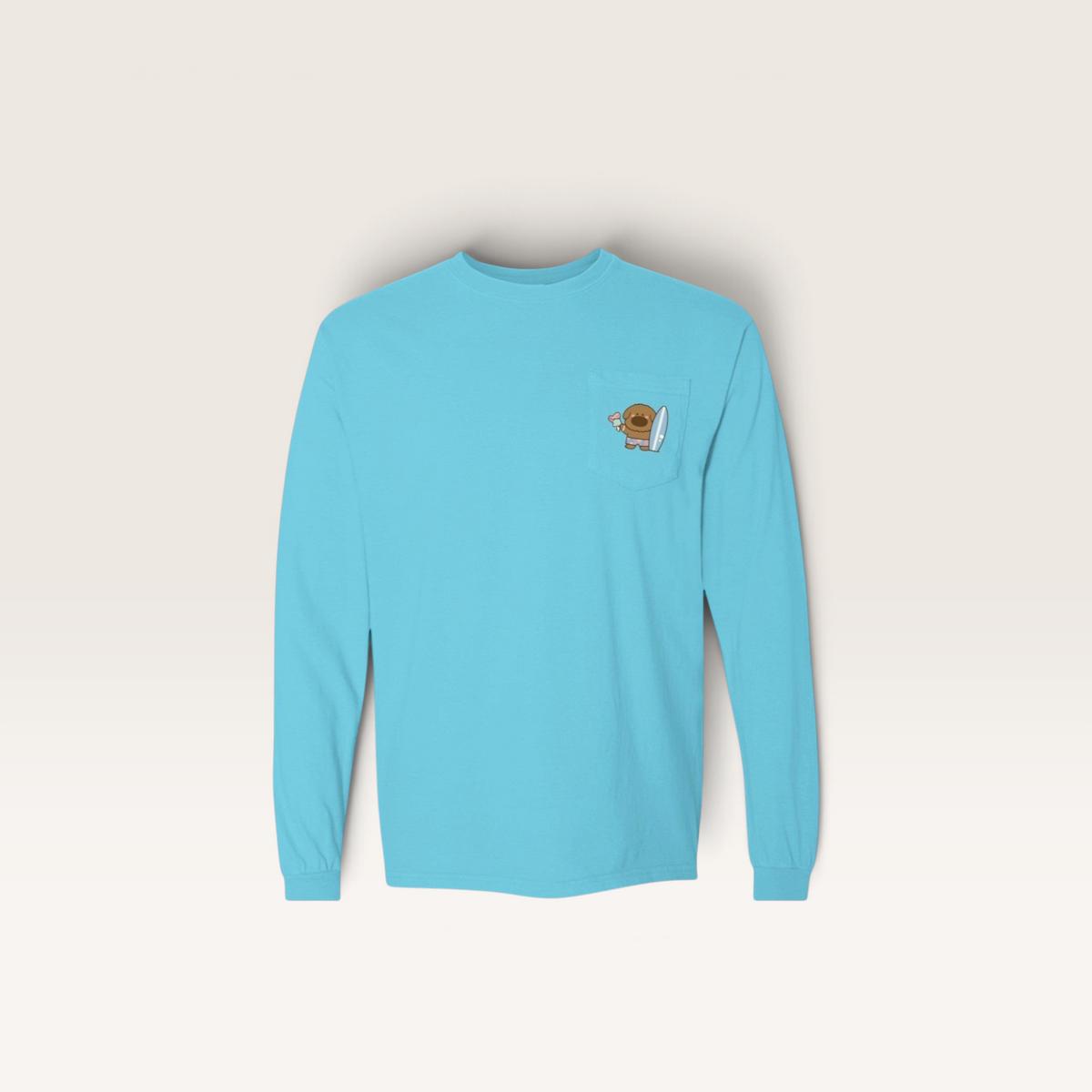 iTsChoCoBu light blue long sleeve pocket t-shirt in soft-washed cotton with a small surfing character chest graphic