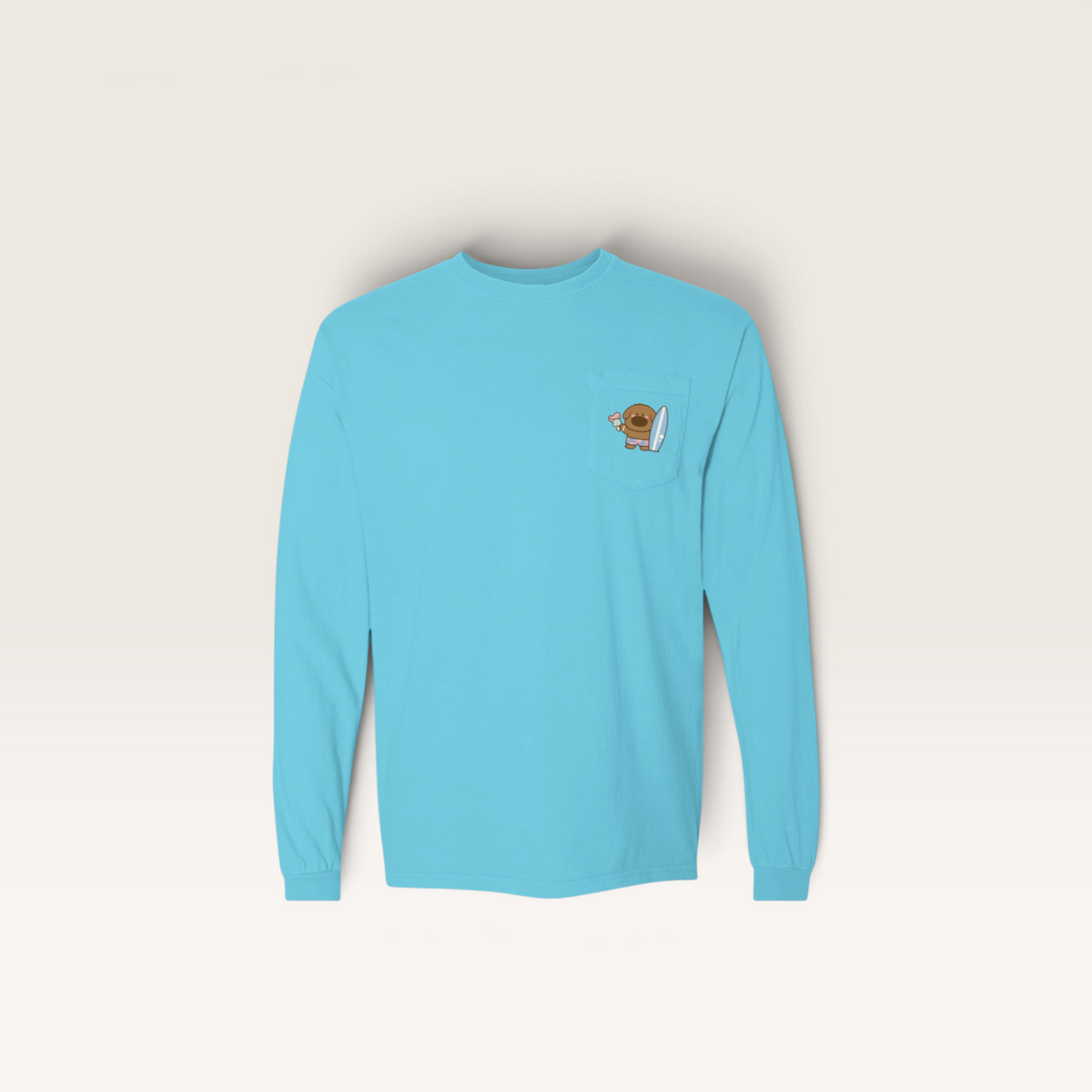 iTsChoCoBu light blue long sleeve cotton t-shirt with a chest pocket featuring a cute surfing character graphic