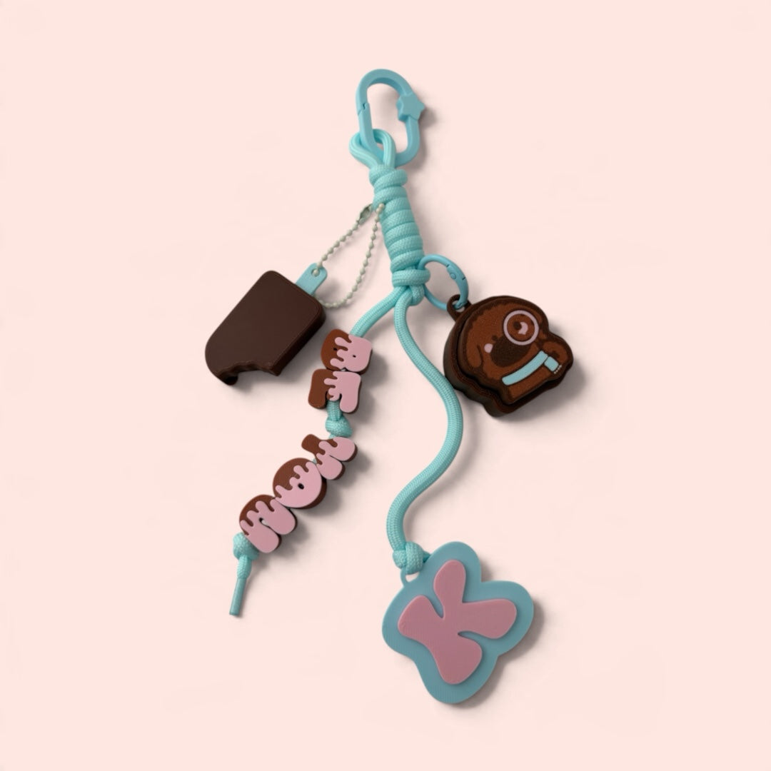 iTsChoCoBu light blue cord keychain with dessert-themed silicone charms, chocolate treat, and letter pendant