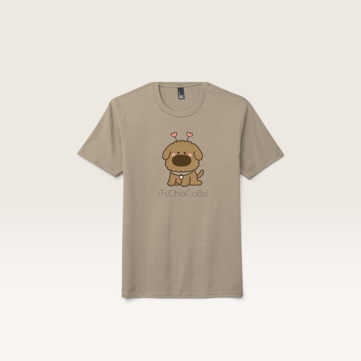 iTsChoCoBu unisex tri-blend t-shirt in heathered beige featuring a cute cartoon dog graphic with heart antennae.
