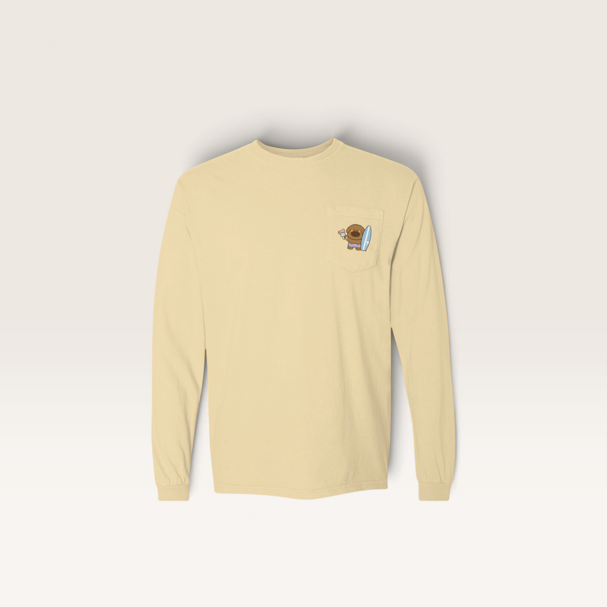 iTsChoCoBu long sleeve pocket t-shirt in light yellow cotton with a small graphic of a bear holding a surfboard